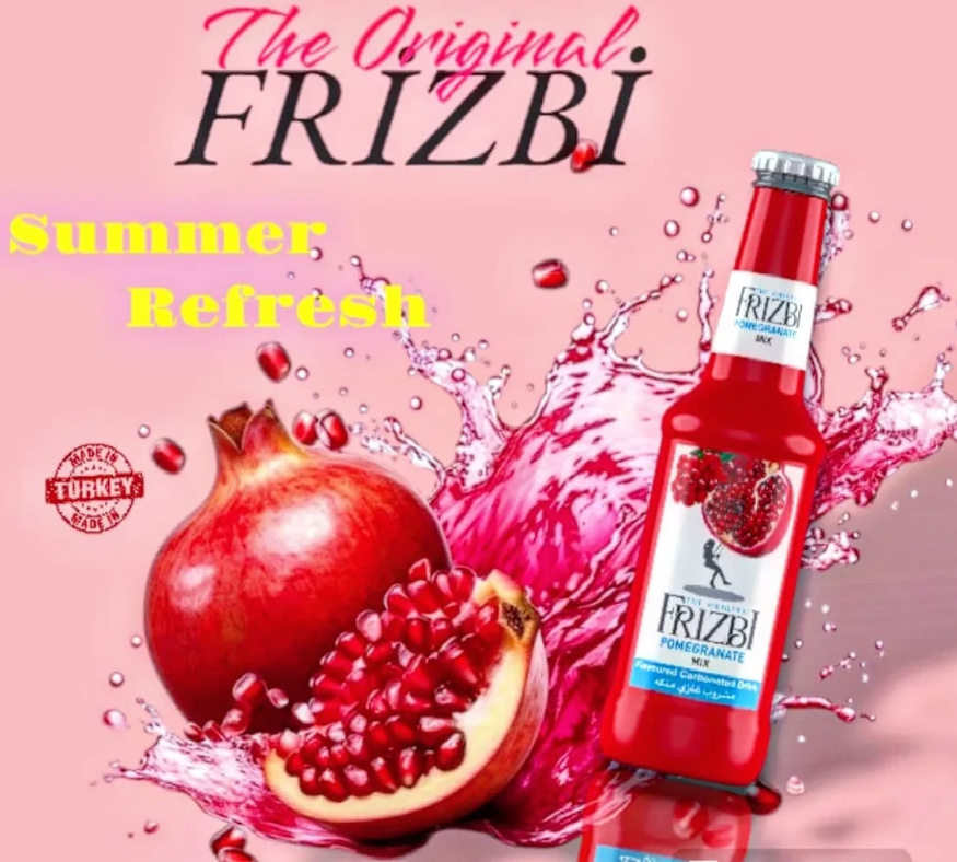 Frizbi pomegranate flavored soft drink bottle placed beside a whole and sliced pomegranate on a pink background.